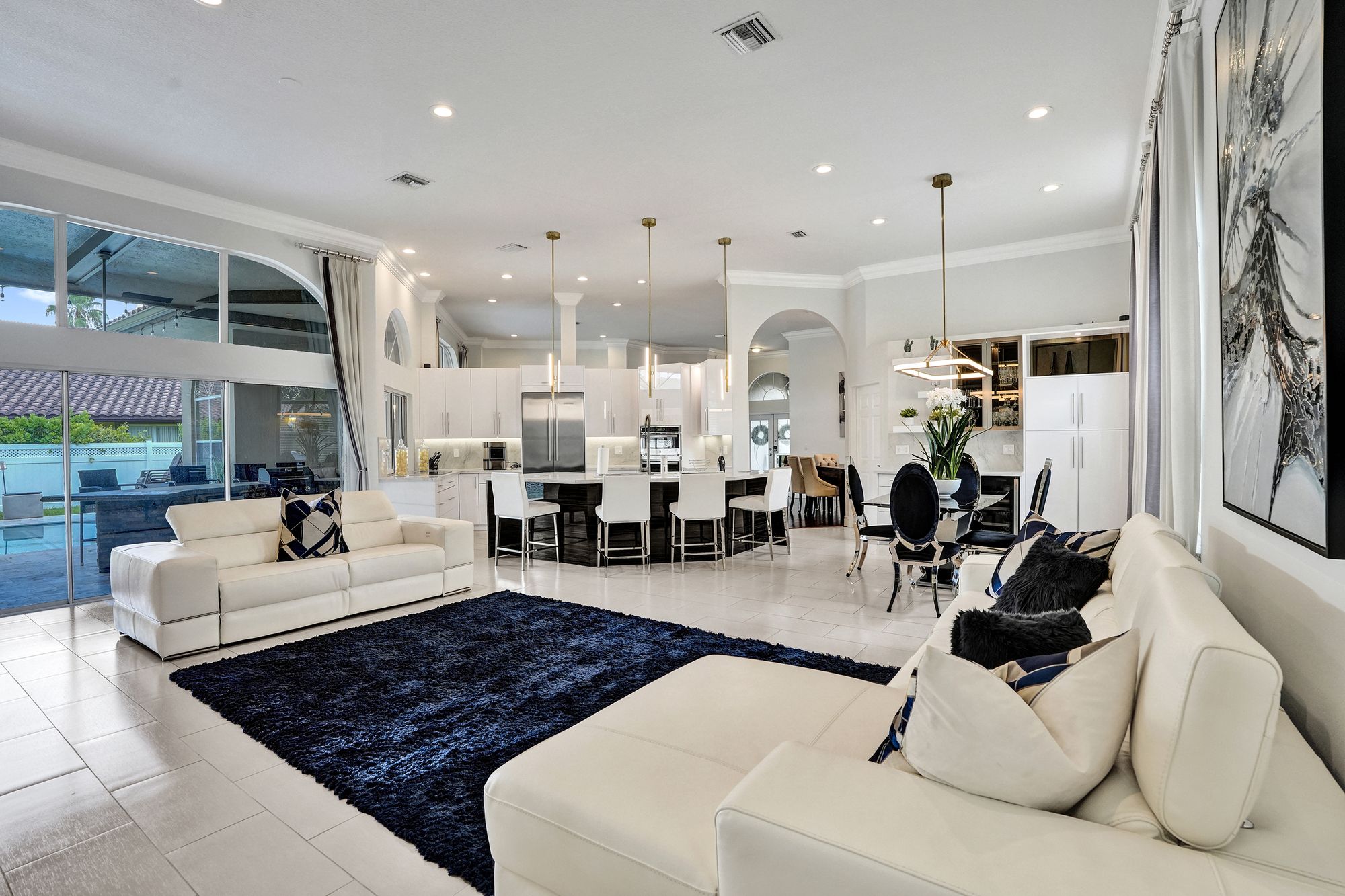 Open living and dining area styled for guests in a South Florida pool home