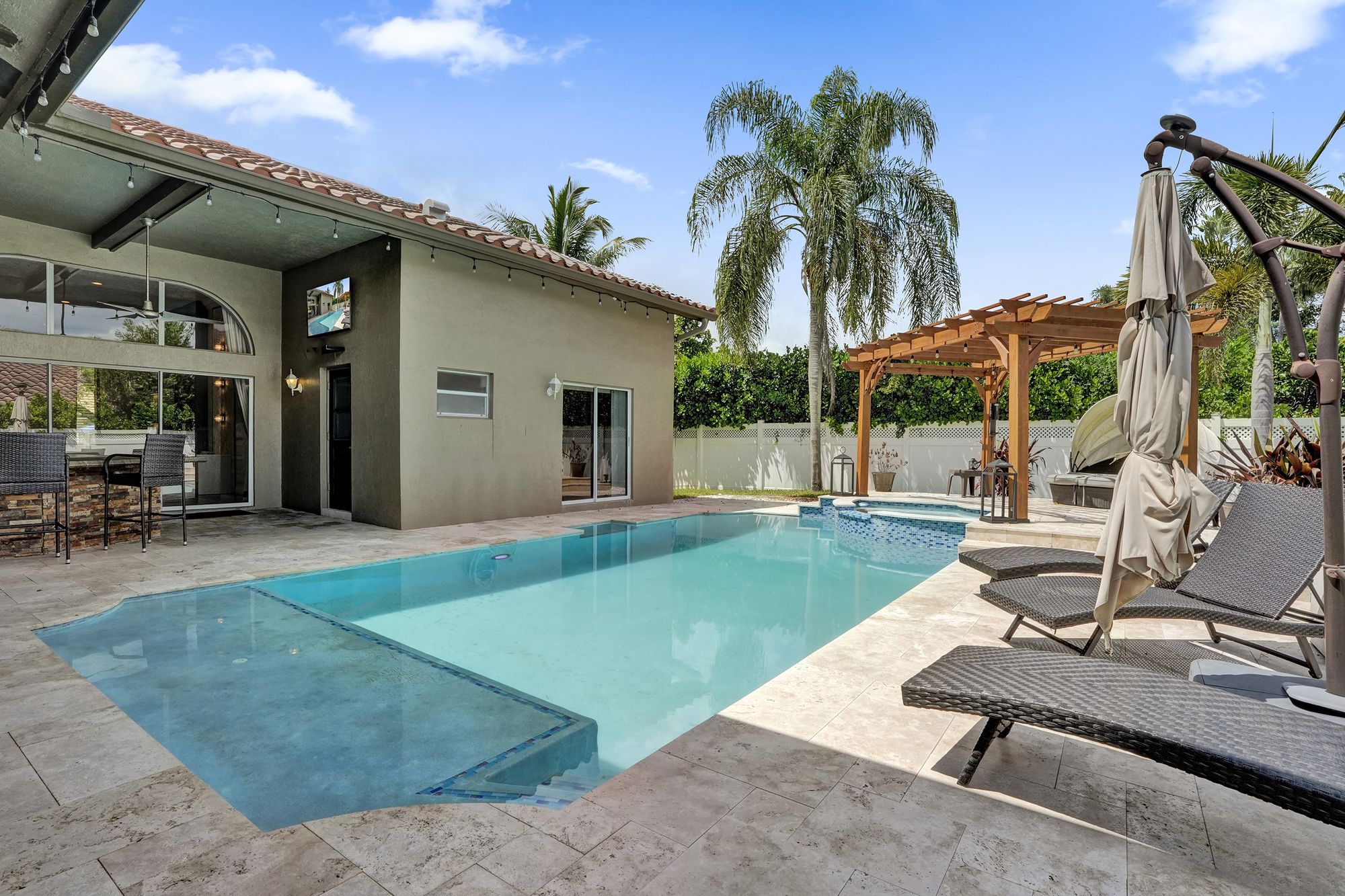 Private pool and outdoor kitchen at a South Florida pool home