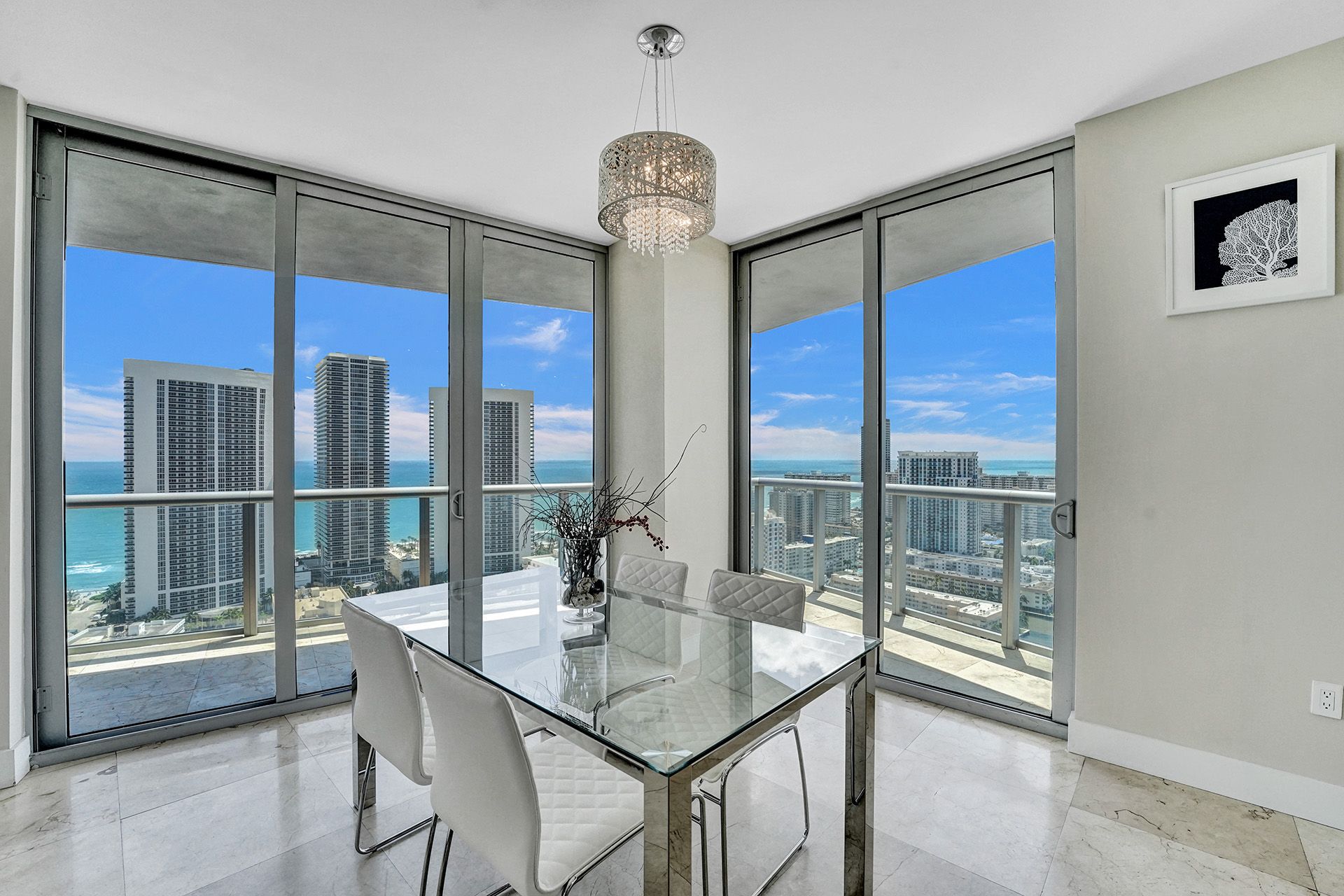 Dining area with floor-to-ceiling windows and ocean views in a Hallandale Beach high rise